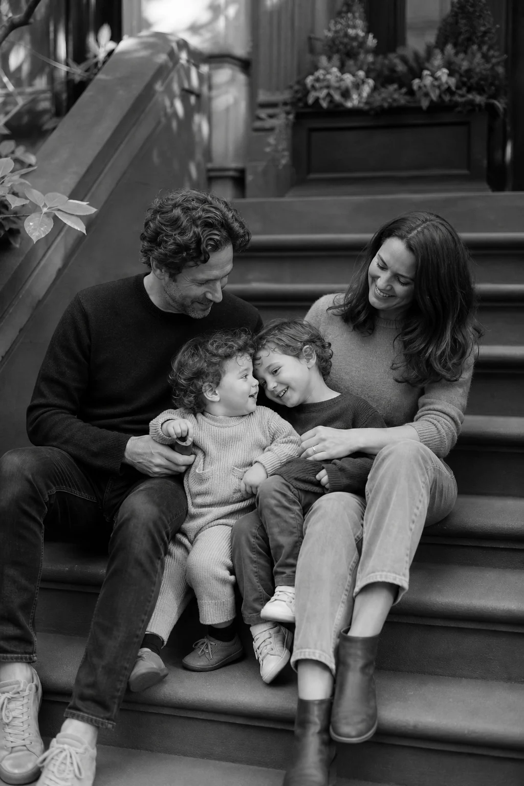 Family sitting on a brownstone stoop